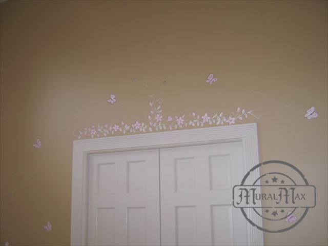 We painted delicate flowers and vine above the closet door